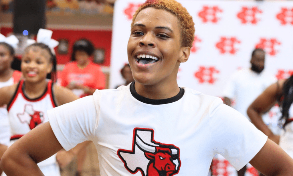 Teenage male cheerleader smiling